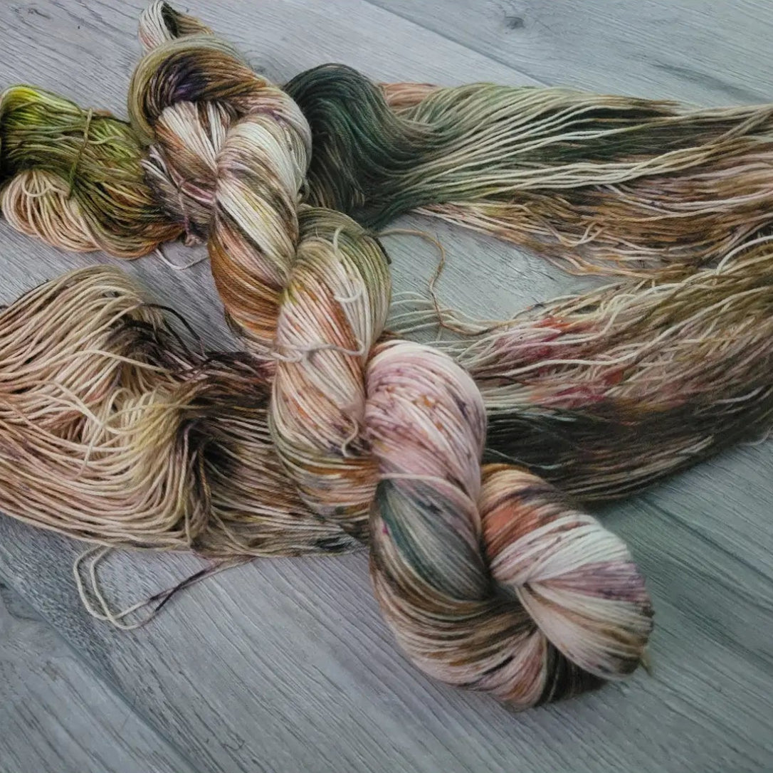 Multicolored yarn skeins on a wooden surface